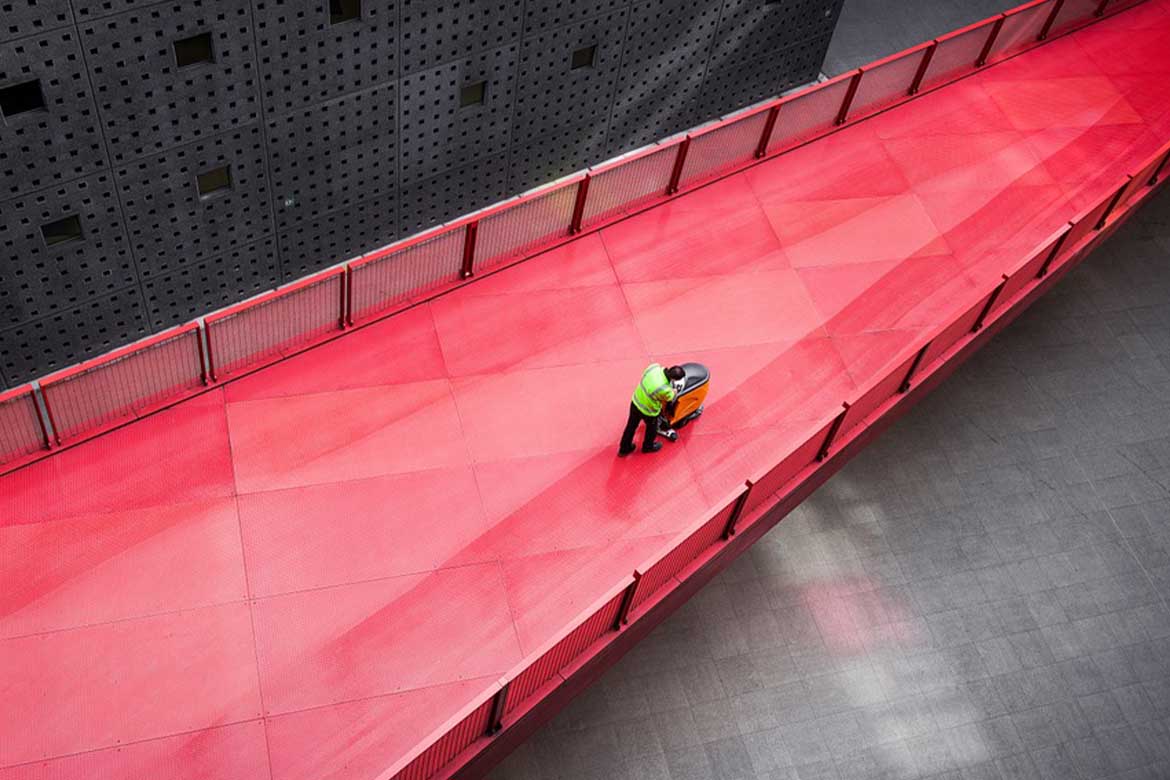 Staff cleaning the floor with heavy duty equipment